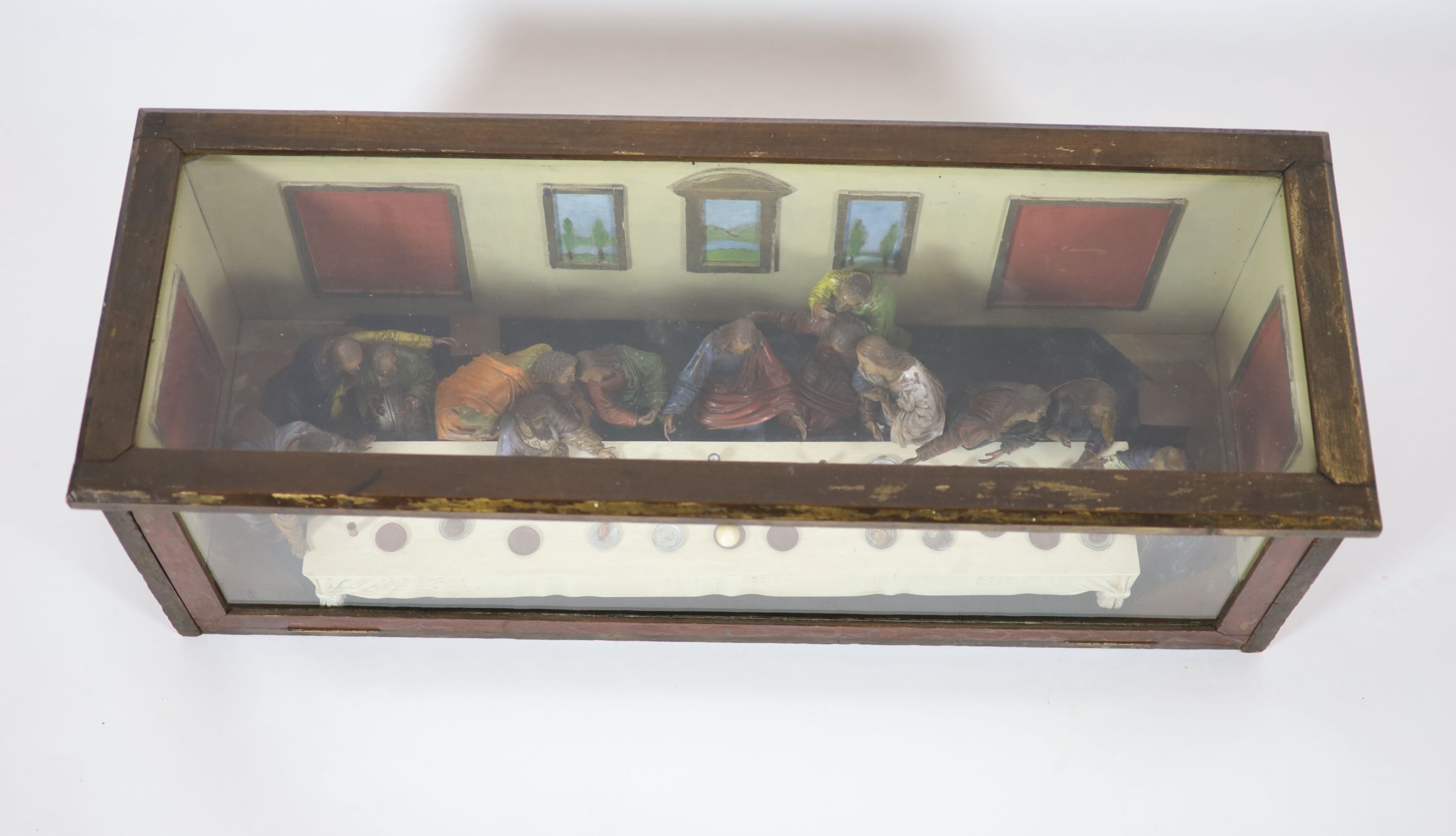 Attributed to Hans Mayr (active 1870) - a carved and painted limewood tableau of The Last Supper, after Leonardo da Vinci, dated 1872 32cm high, 94 x 33cm.